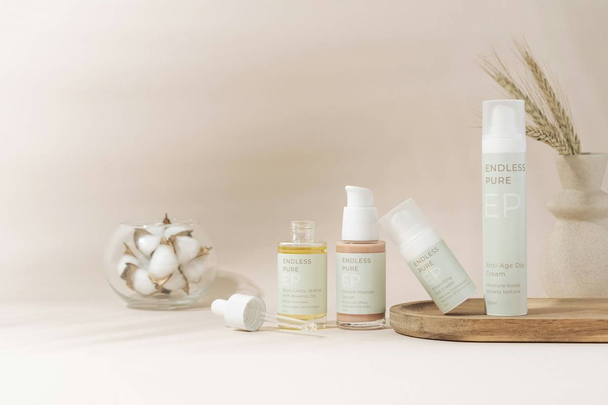 Bottle of witch hazel next to cotton pads with text overlay: is witch hazel considered a toner